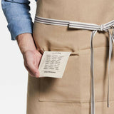 Delantal Oslo Cross-Back Beige Natural con bolsillo.