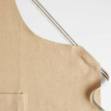 Delantal Oslo Cross-Back Beige Natural con bolsillo.