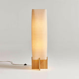 Lámpara de pie de madera Toro con pantalla tejida.