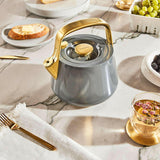 Caraway Home ® Graphite Stovetop Whistling Tea Kettle with Gold Hardware.