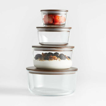 Crate & Barrel 8-Piece Round Glass Storage Containers with Dark Wood Lids.