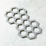 Salvamanteles grises de silicona entrelazados, juego de 2.