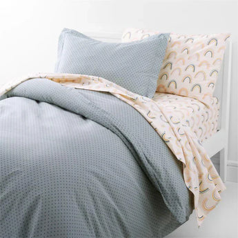 Crate & Barrel soft bedding set with pastel dotted duvet and rainbow print sheets on modern bed – textiles up to 30% off