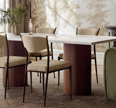 Dining table with green armchairs and light dining chairs in a Mix & Match arrangement_Crate&Barrel Costa Rica