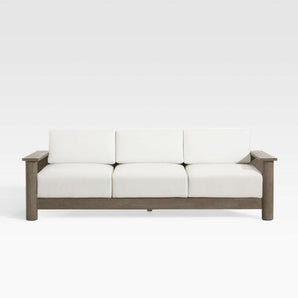 Ashore Grey Wood Outdoor Sofa with White Cushions.